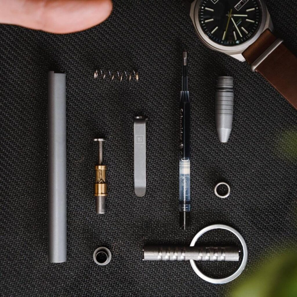 Clean lubrication for titanium pen click mechanism
